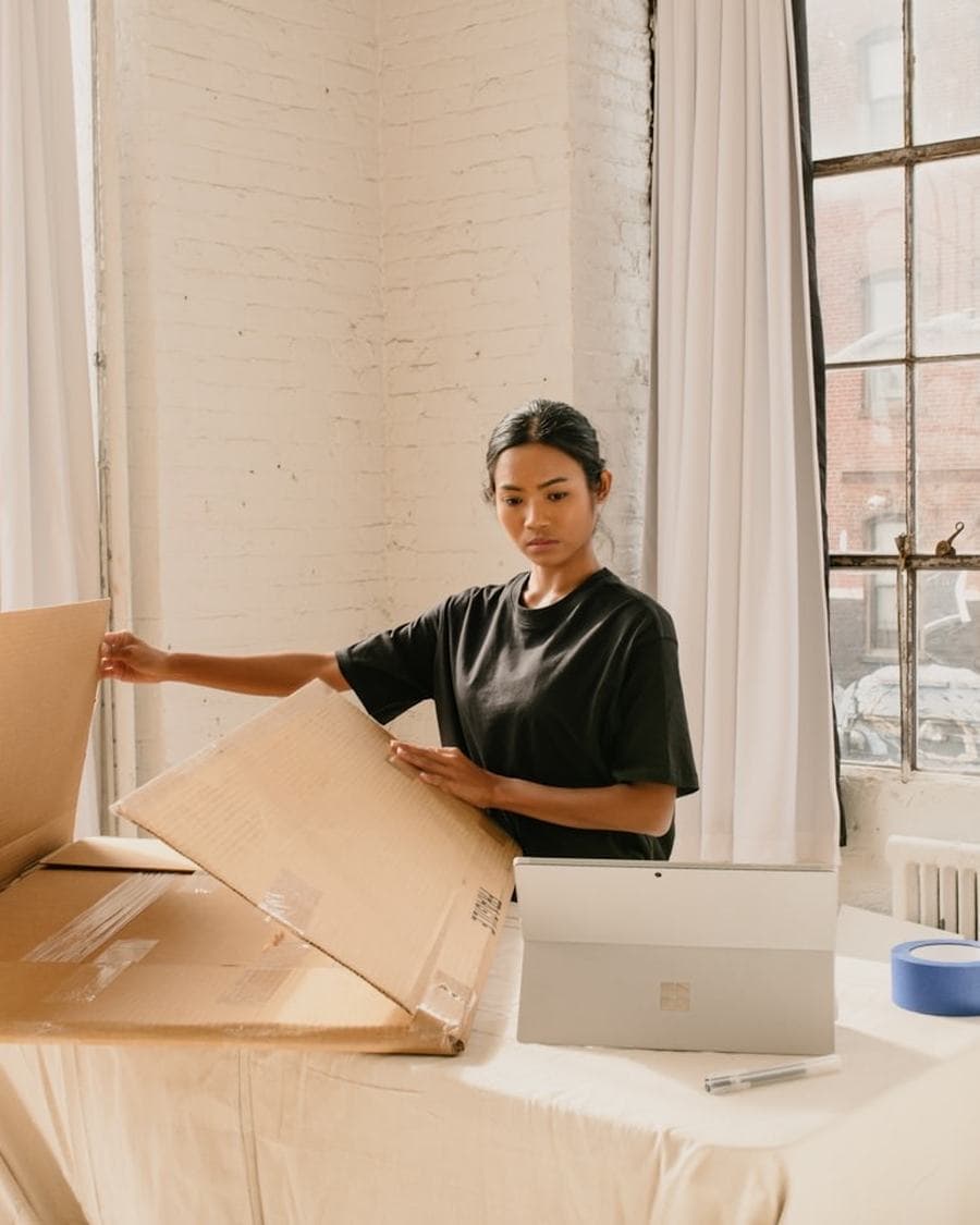 Maker packing a wholesale order into a box