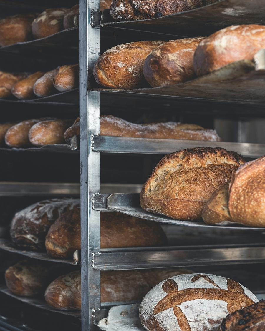 Fresh loaves cooling on bakery racks